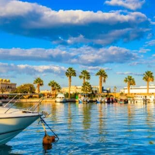Scenic waterfront with boats and palm trees Hurghada City Sightseeing Tour
