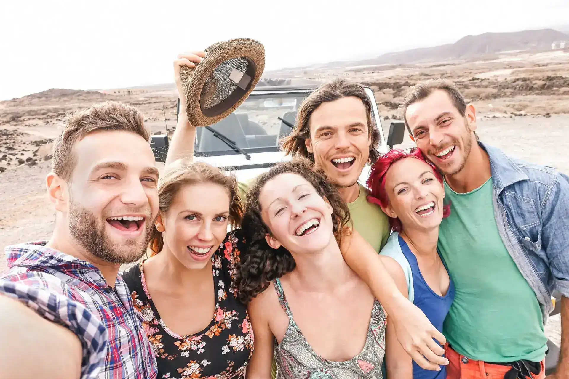 Group of travel friends taking selfie in the desert during their Egypt tour How Safe Is Luxor.