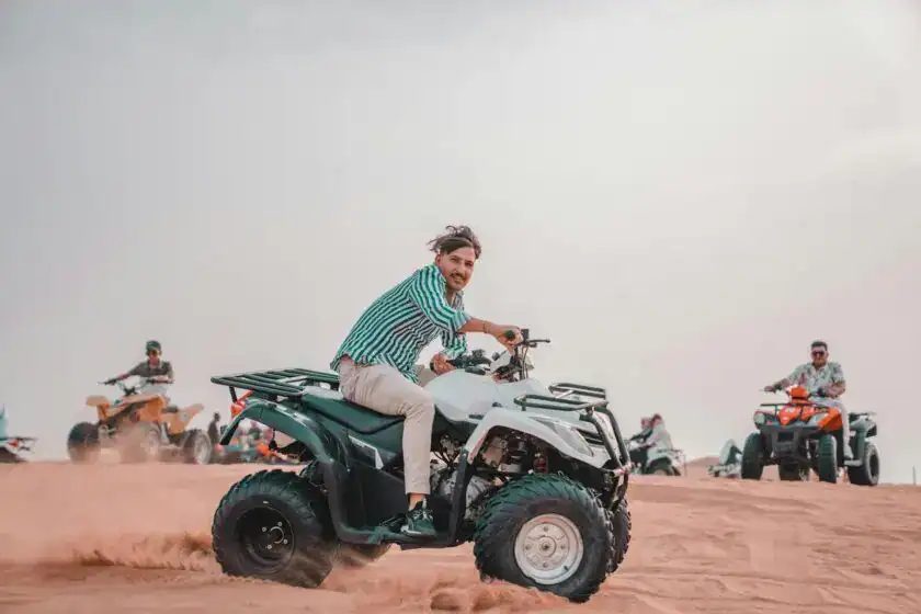 Group riding quads in a vast desert Why Egypt's Desert Safari Is a Must-Do Adventure