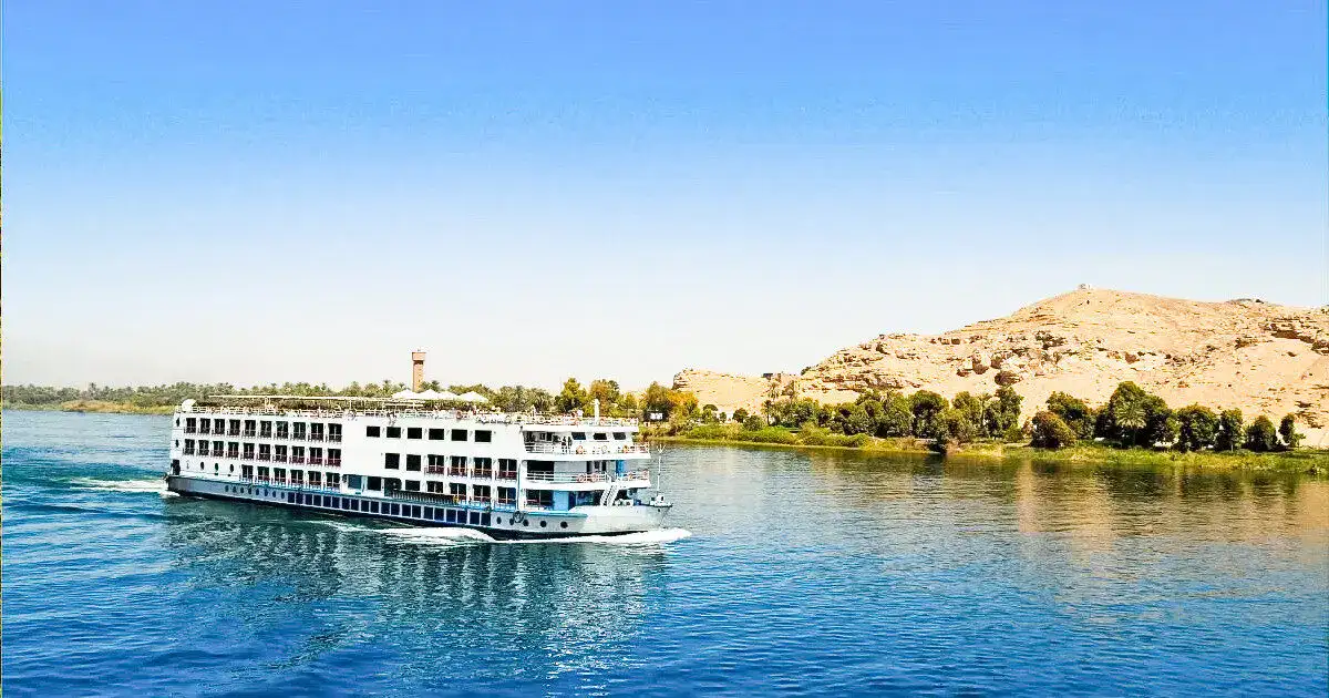 cheap nile cruise ship on the river at sunset