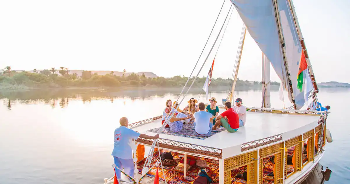 Small group of travelers enjoying an Egypt group tours at the Pyramids of Giza