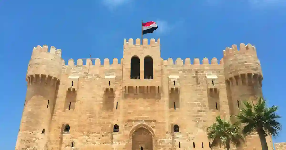 The Citadel of Qaitbay in Alexandria Egypt glowing at sunset over the Mediterranean Sea